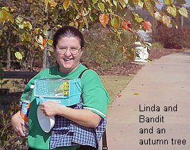 Linda and Bandit under a fall tree